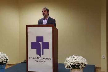 A man stands on a podium of the General Hospital of Grevena
